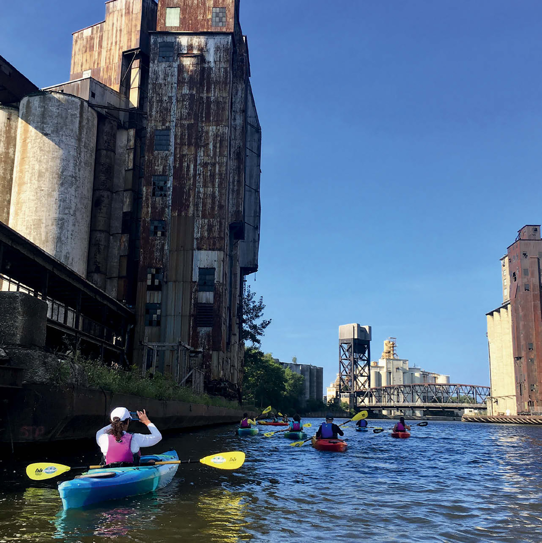 People kayaking near the Buffalo grain silos.