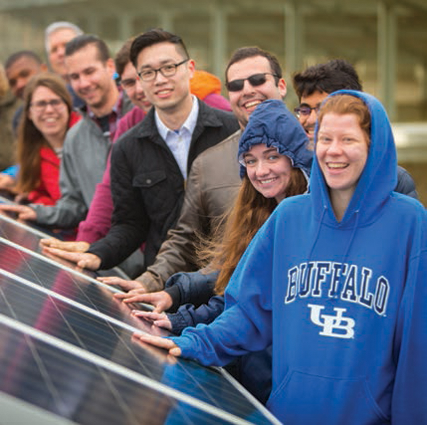 Ten people touching the Solar Strand panels on North Campus.
