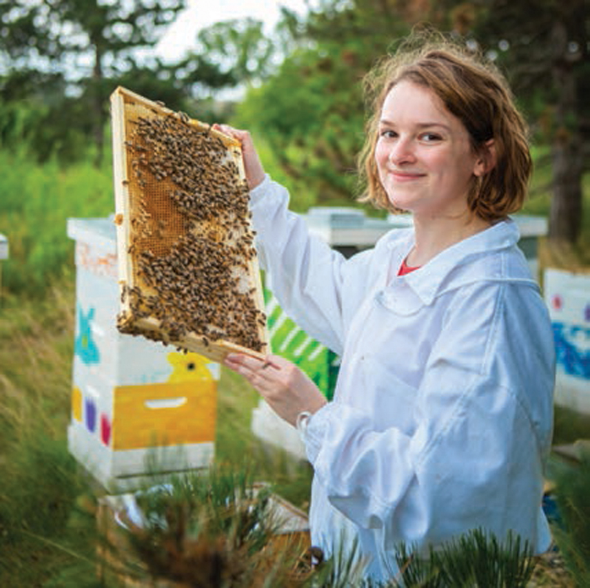 UB student Alexandra Dombrowski takes care of bees at a hive on North Campus.