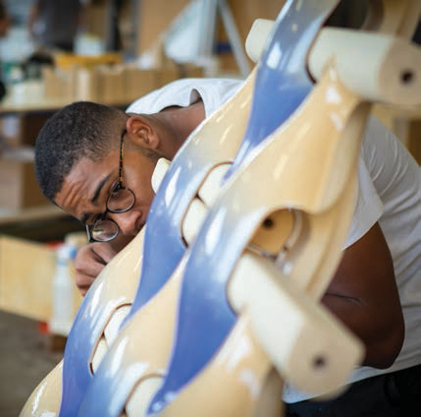 A student examines a project very closely.